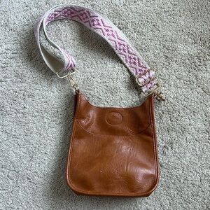 Ah-dorned saddle bag with guitar strap